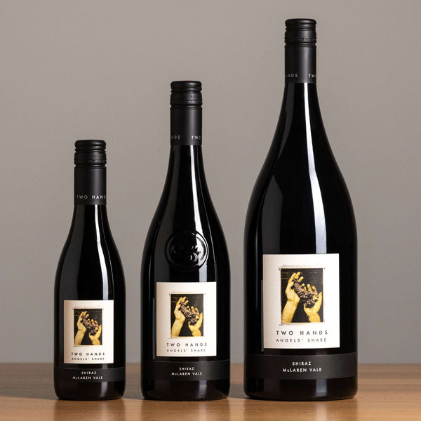 Three bottles of Angels' Share Shiraz in 375mL, 750mL and magnum on a wooden surface with a neutral background