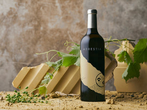 Wine bottle labeled 'Adrestia' with a rustic background