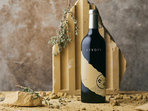 Wine bottle with 'Aerope' label on a rustic background